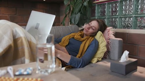 Portrait Young Woman with a Fever Working on a Laptop at Home Lying the Couch Virus Illness Cold Ill