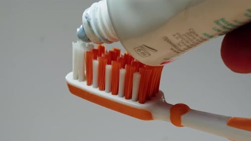 Toothpaste Applied To A Toothbrush In Close Up