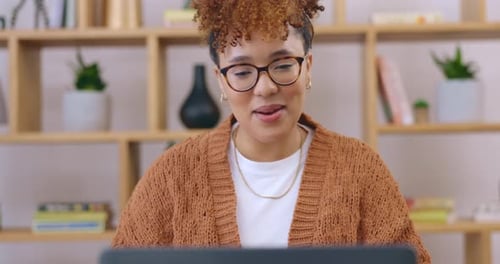 Smiling Woman Waving During Video Call on Laptop