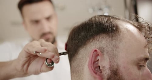 Barber Cuts Man's Hair With Scissors, Close Up