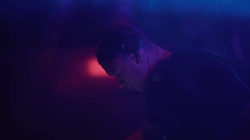 Side View of Black Male DJing at the Club