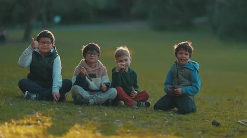 Four Boys Sit Together Giving Thumbs Up