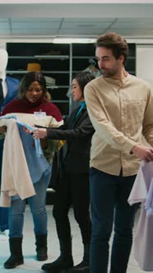 Vertical Video Male Store Assistant Helping Client to Buy Shirts at Mall