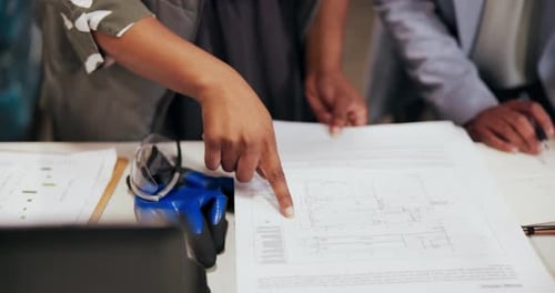 Architects Reviewing Plans Together at Workplace