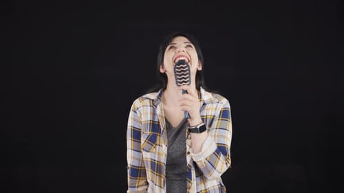 The woman is singing.