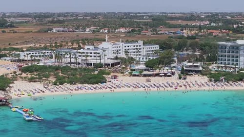 Aerial View of Ayia Napa Coastline with Beachfront Resort and Town