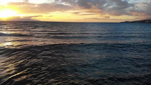 Breathtaking sunset over the ocean waves in Tenerife reveals natures beauty