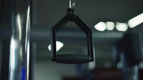 Single pulley handle hang from indoor weightlifting gym equipment