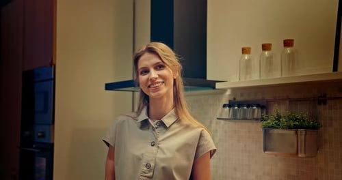 Blonde Woman Smiling in Bright Indoor Kitchen