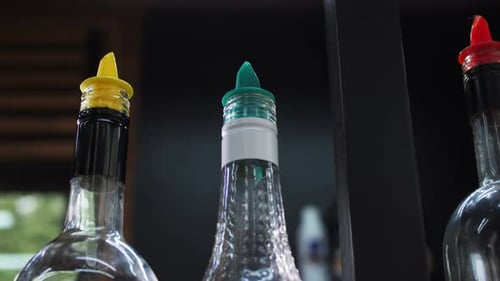 Collection of Bottles on Countertop in Contemporary Cafe