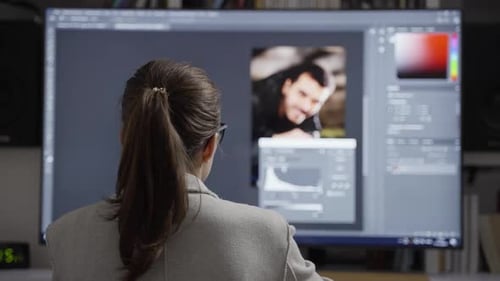 Woman Edits Photo on Computer in Workplace