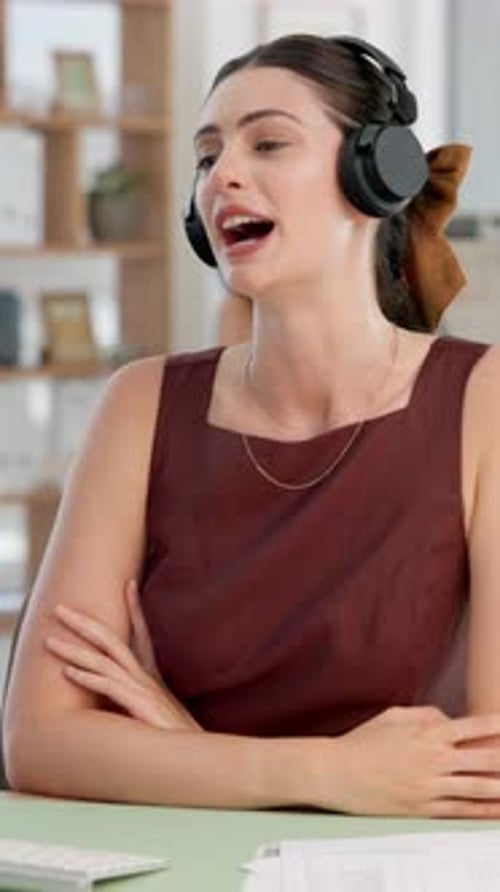 Media agency, video call and woman in office, headphones and communication with virtual meeting