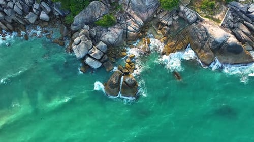 Waves crushing on rocks on the beach.