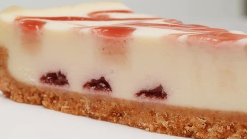 Delicious Cheesecake Slice with Strawberry Swirl Close Up