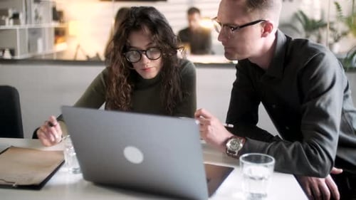In Creative Office Productive Coworkers Standing at the Table Company Meeting Businessman And Woman