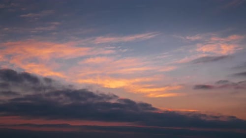 Majestic Clouds Moving Across the Sky at Sunrise