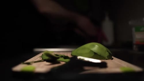 Cutting Avocado on Wooden Cutting Board at Home