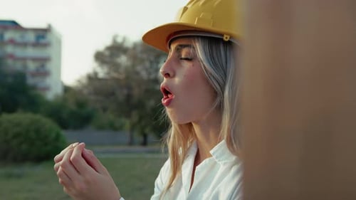 Female Construction Worker Chewing Outdoors