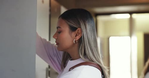 University, education and woman with books in locker for class, lesson and learning at academy