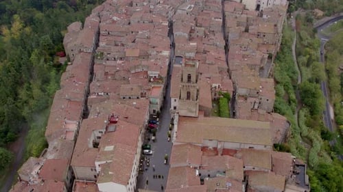 Aerial view of medieval village with cathedral and tower, Italy.