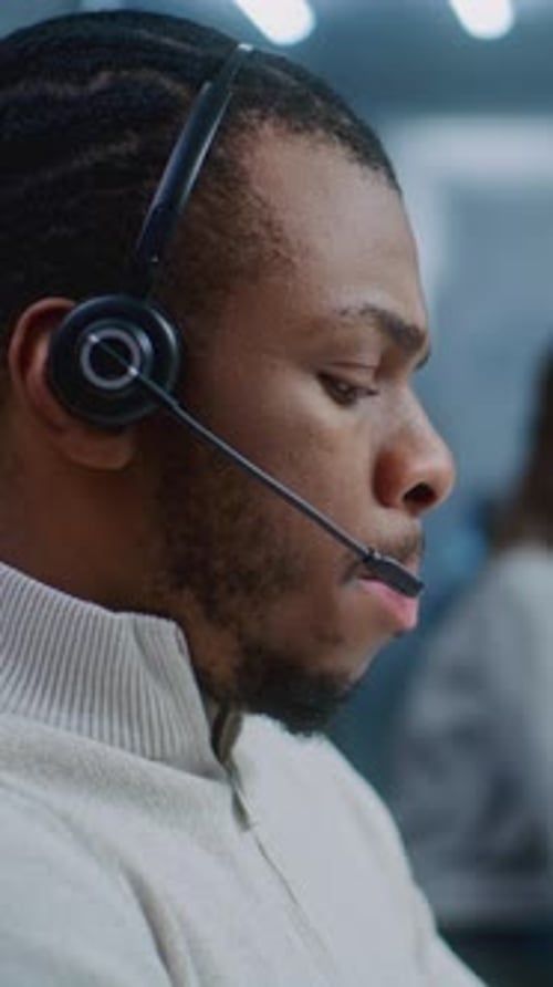 Close Up Portrait of African American Technical Support Specialist in Headset Consulting Client