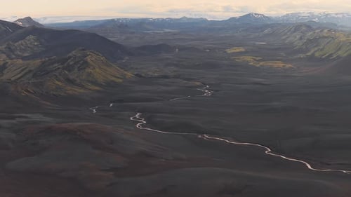 Aerial View of Iceland's Volcanic Plains Rivers and Mossy Mountain