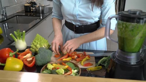 Woman Preparing Vegetables in Bright Modern Kitchen