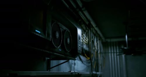 Computer Hardware with Cooling Fans in Dark Industrial Setting