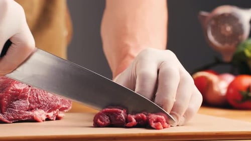 Close Up of Chef Slicing Raw Meat