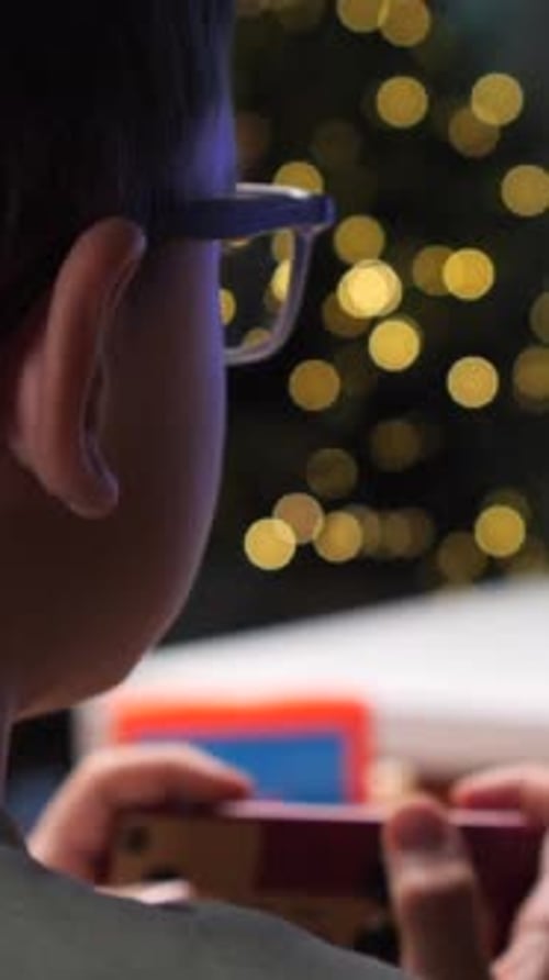 Vertical Video Young Boy Playing a Retro Platform Videogame on a Crt Tv