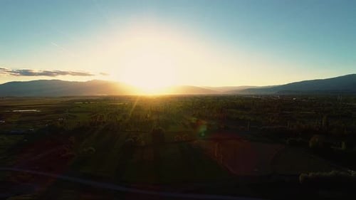 Aerial Sunset Over Rolling Green Countryside