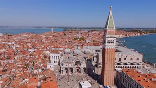 Admire the Basilica in Venice from the sky, where intricate details meet the vibrant life of the cit