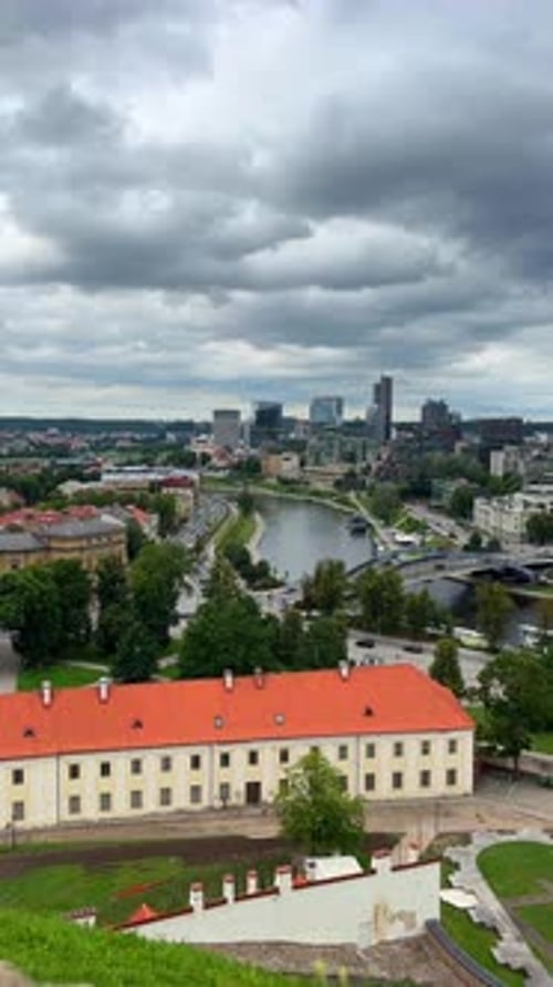 View of the Neris River in Central Vilnius with Bridge and Modern Skyline in Background –