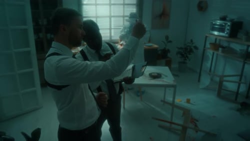 Detectives Investigating Crime Scene Evidence at Apartment