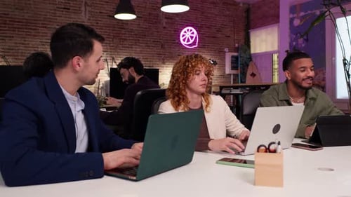 Three Young Adults Collaborating in Modern Office