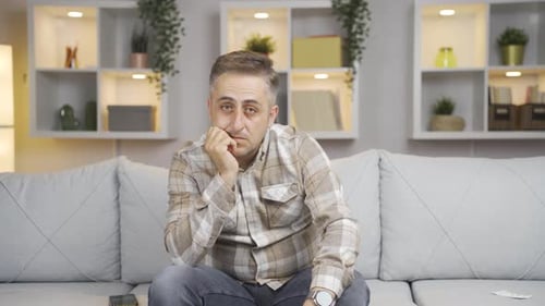 Man looking thoughtfully at camera.