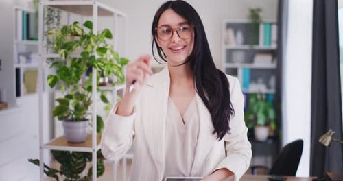 Confident Woman in Cream Blazer Smiling in Office