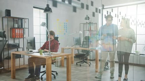 Young Woman and Man Colleagues Walking in the Office while Having a Friendly Discussion About New B