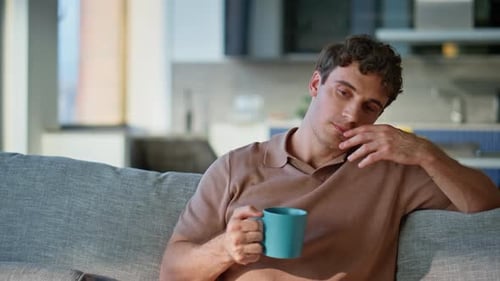 Man Drinking Coffee and Relaxing at Home