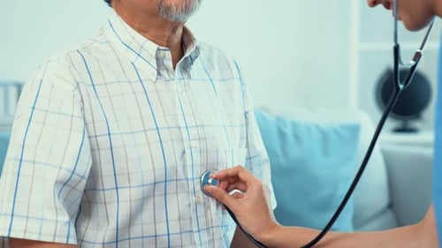 Doctor Checks Senior Man Heart with Stethoscope