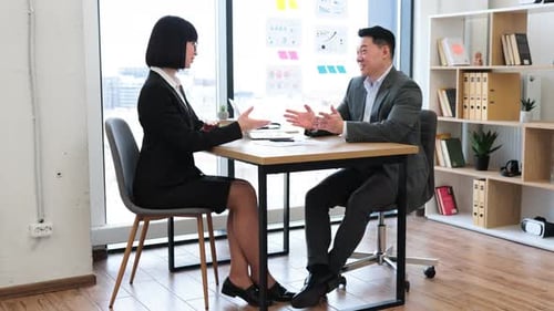 Business Agreement Sealed with Handshake in Modern Office Setting