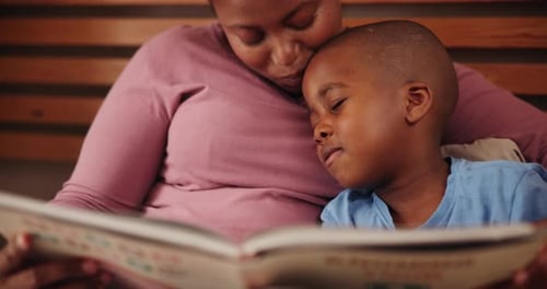 Mother Reading to Child in Bed