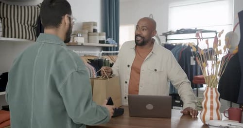 Man Paying in Clothing Store with His Phone