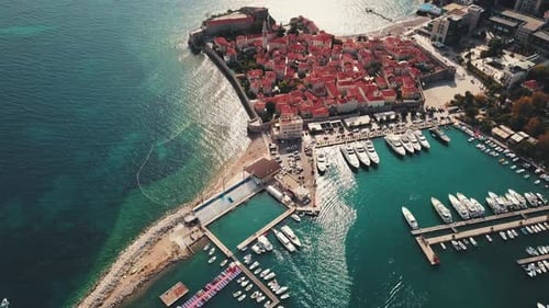 Aerial view of drone flying over the marina and old town in Budva, Montenegro, Balkans. Adriatic sea