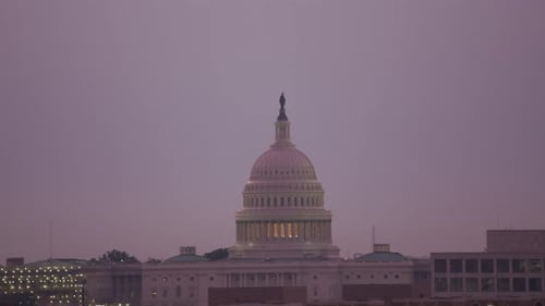United States capitol building reveal at sunrise Washington dc aerial view