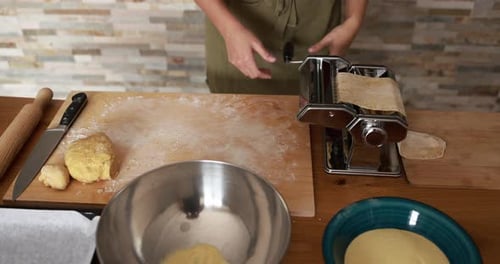 Home Cook Using a Manual Pasta Machine to Roll Fresh Dough