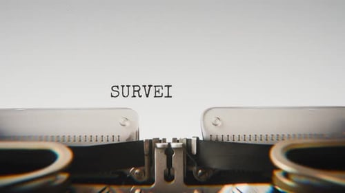 Old mechanical typewriter typing Surveillance Active in a close-up view.