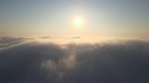 Golden Sky Above Rolling Clouds Aerial View