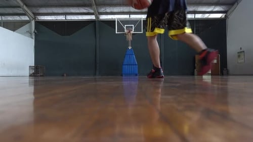 Basketball player practicing dribble and shooting at indoors court. 4K UHD