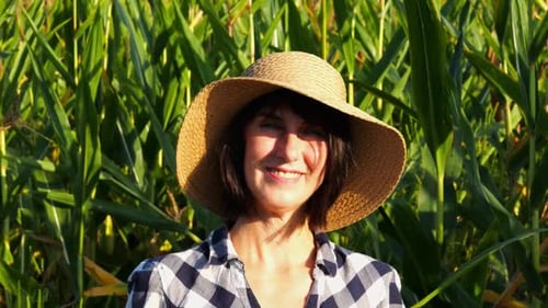 Happy Smiling Female Farmer Looks Into Camera Standing Near Corn Field Portrait of Adult Beautiful